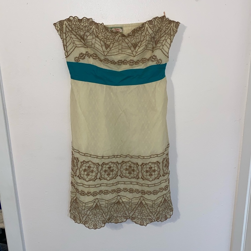 Large tan strapless mini dress with brown embroidery and a tear bow